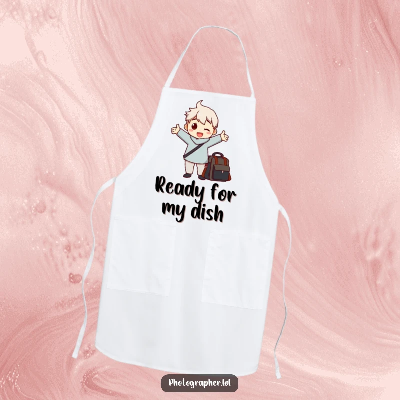 Funny apron with a character striking a dramatic pose with arms outstretched next to a camera bag, a humorous accessory.