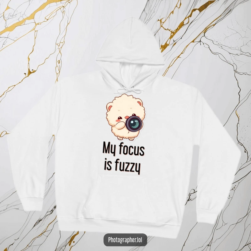 Funny fluffy photographer hoodie, cozy sweatshirt with a cheerful character snapping a camera, lens cap flying off.