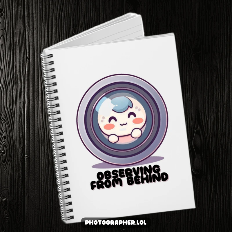 Funny blushing character peeking from behind a camera lens on a notebook cover, a humorous and inspiring writing tool.