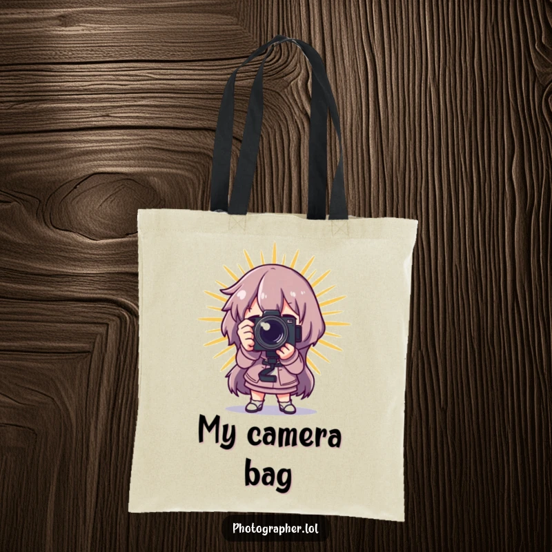 Funny photographer tote bag featuring a character posing dramatically with a camera and a starburst, perfect for carrying gear.
