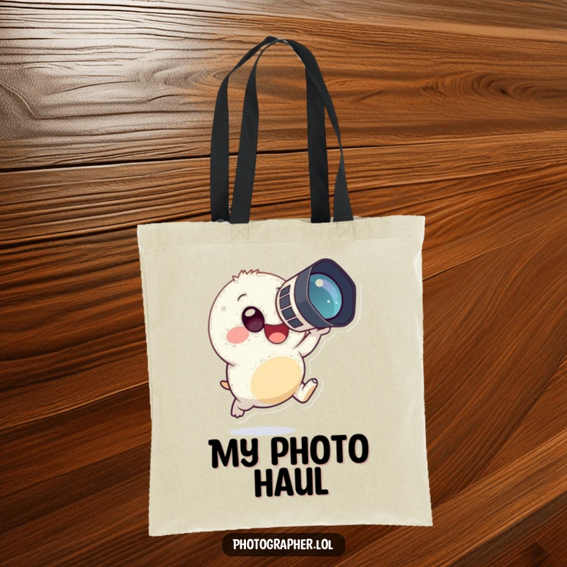 Funny tote bag showing a small, round creature in mid-leap, happily holding a large camera to its eye, embodying photographic fun.